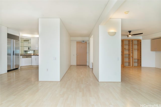 empty room featuring light wood-type flooring and ceiling fan