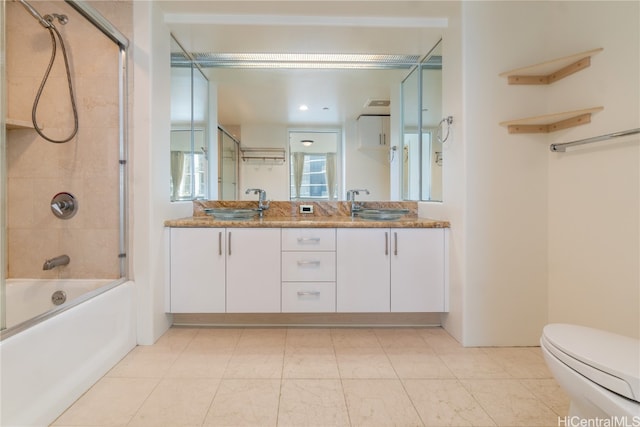 full bathroom with toilet, bath / shower combo with glass door, and vanity