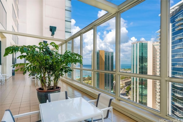 sunroom featuring a water view