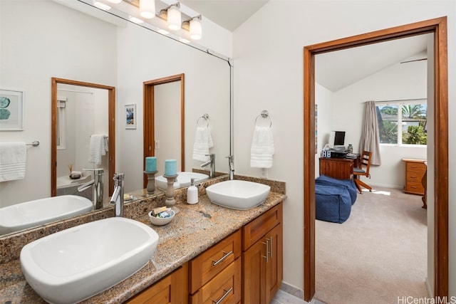 bathroom with vanity and vaulted ceiling