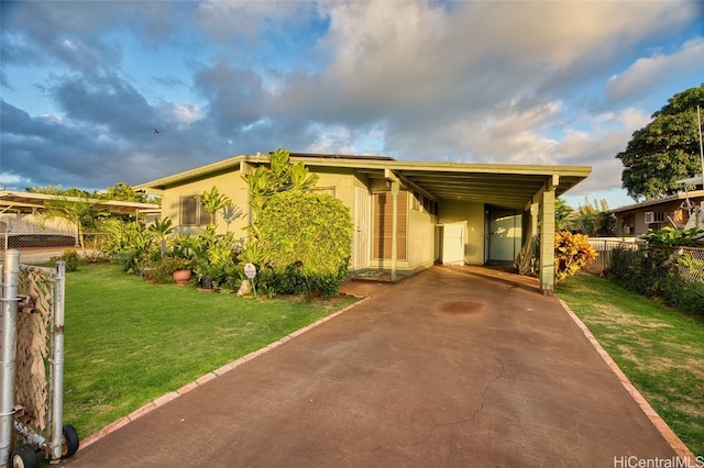 view of front of property with a front lawn and a carport