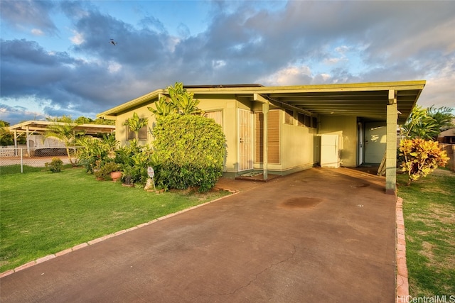 view of front of property with a front lawn and a carport