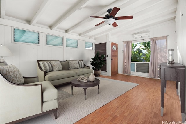 living room featuring light wood-type flooring, an AC wall unit, ceiling fan, wooden walls, and beam ceiling