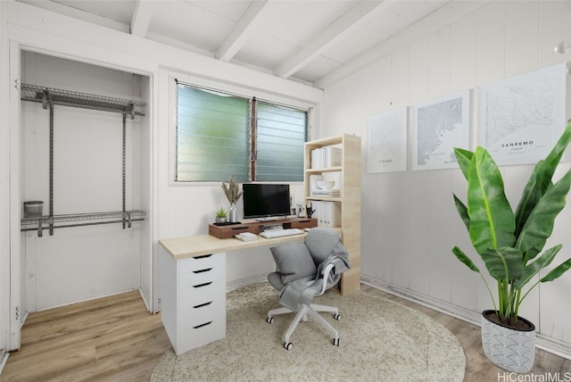 home office featuring beamed ceiling and light wood-type flooring