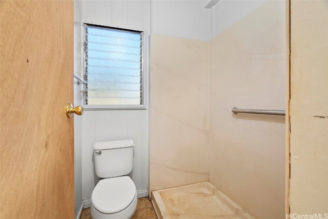 bathroom featuring tile patterned floors, a shower, and toilet