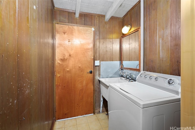 laundry area featuring washer / dryer and wooden walls