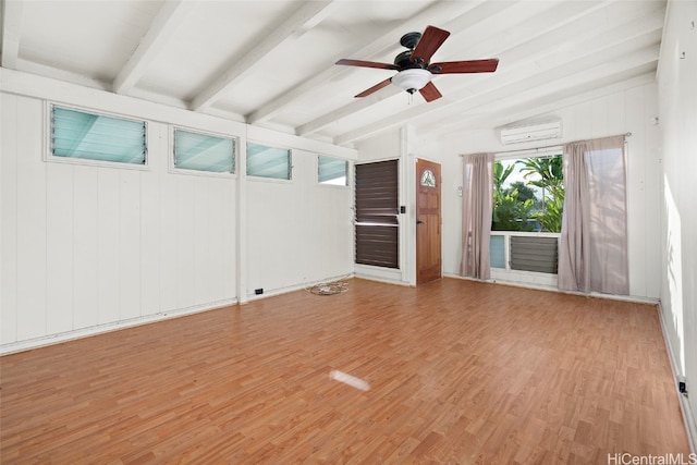 interior space featuring ceiling fan, an AC wall unit, light hardwood / wood-style floors, lofted ceiling with beams, and wooden walls