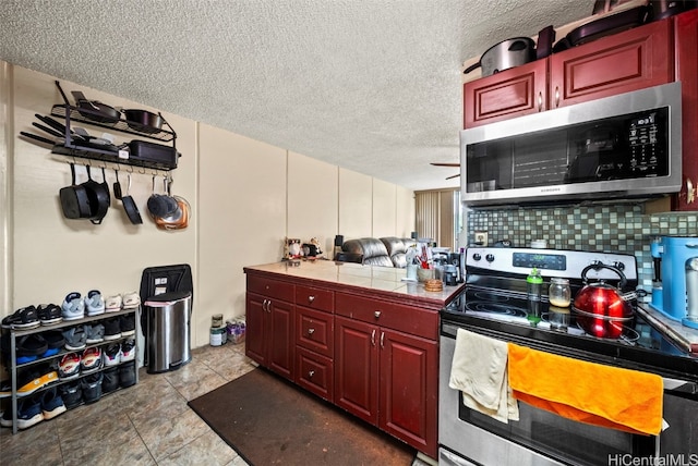 kitchen with tasteful backsplash, tile countertops, a textured ceiling, and appliances with stainless steel finishes