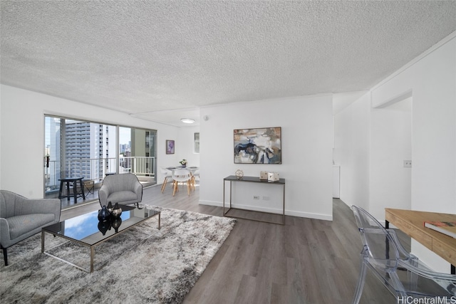 living room with dark wood-type flooring and a textured ceiling