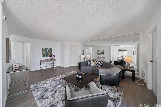 living room with a textured ceiling and hardwood / wood-style flooring