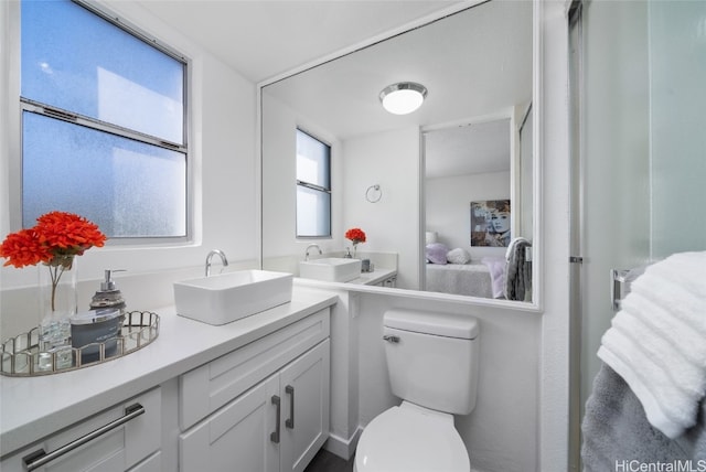 bathroom featuring toilet and vanity