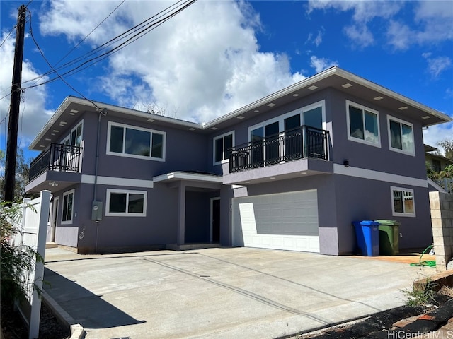 view of front of property with a balcony and a garage