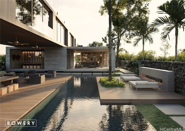 view of pool featuring ceiling fan, a wooden deck, and an outdoor living space with a fireplace