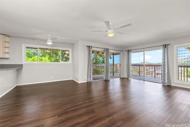 spare room featuring dark hardwood / wood-style floors, plenty of natural light, and ceiling fan