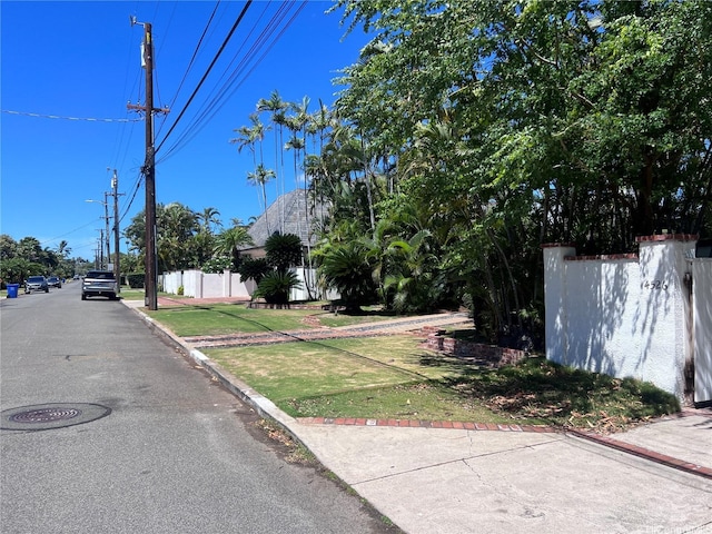 view of street with curbs, street lights, and sidewalks