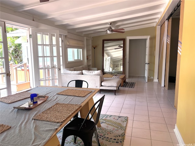 dining space featuring light tile patterned floors, ceiling fan, plenty of natural light, and beamed ceiling
