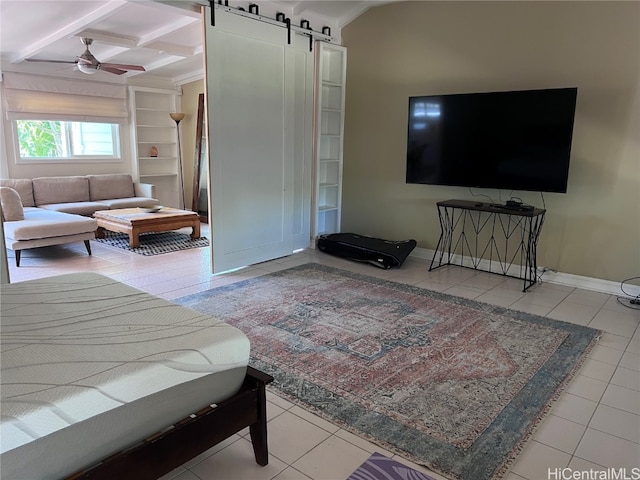 interior space with beamed ceiling, a barn door, built in features, and ceiling fan