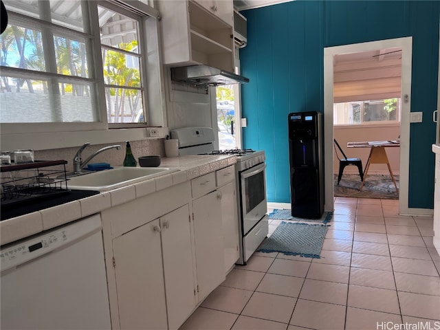 kitchen featuring white cabinetry, tile countertops, plenty of natural light, and white appliances