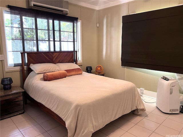 bedroom with light tile patterned floors, a wall unit AC, and ornamental molding