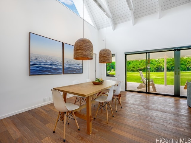 sunroom featuring lofted ceiling with skylight, wood ceiling, and plenty of natural light