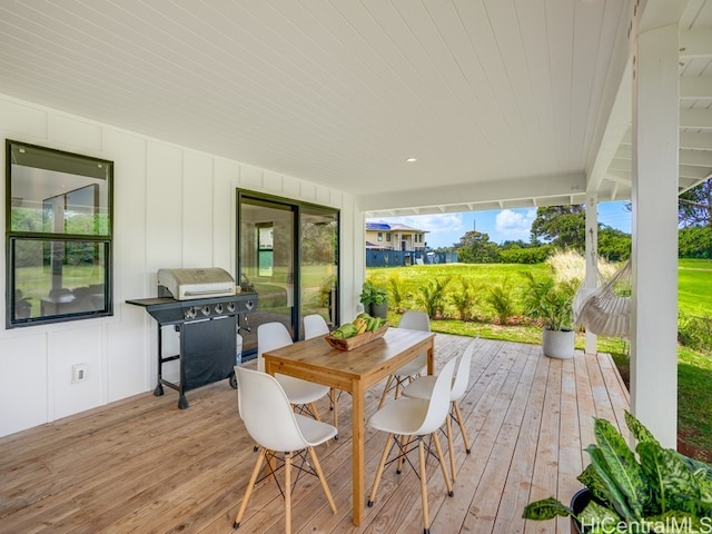 wooden terrace featuring a grill