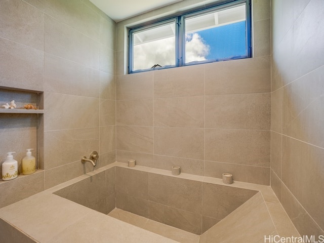 bathroom featuring a tile shower