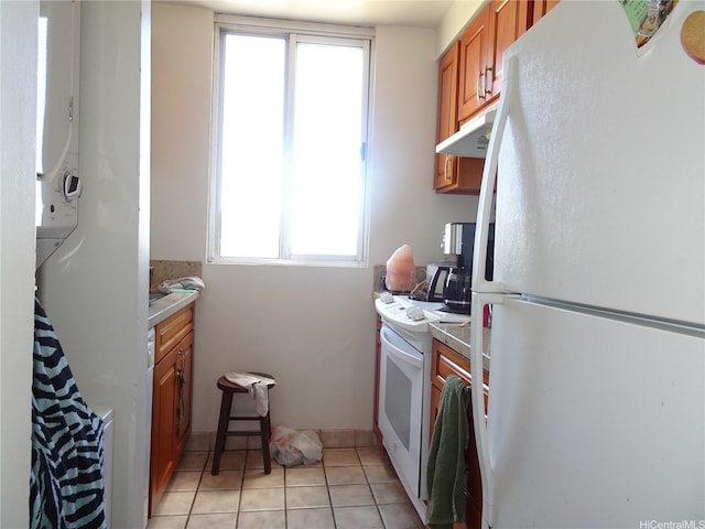 2916 Date St Unit 18B, Honolulu, HI 96816 - kitchen with white appliances, under cabinet range hood, brown cabinets, light tile patterned floors, and light countertops