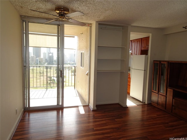 2916 Date St Unit 18B, Honolulu, HI 96816 - unfurnished dining area with plenty of natural light, a ceiling fan, wood finished floors, a textured ceiling, and baseboards