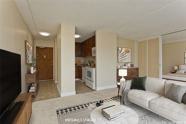 carpeted living room featuring sink and a textured ceiling