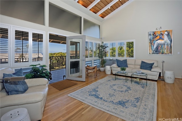 living room featuring hardwood / wood-style floors, high vaulted ceiling, and wood ceiling