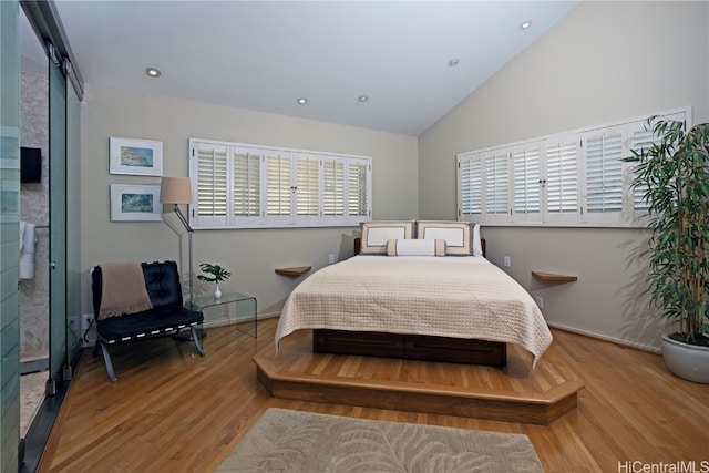 bedroom with hardwood / wood-style flooring and vaulted ceiling