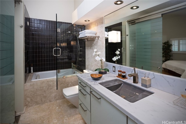 full bathroom featuring shower / bath combination with glass door, vanity, and toilet