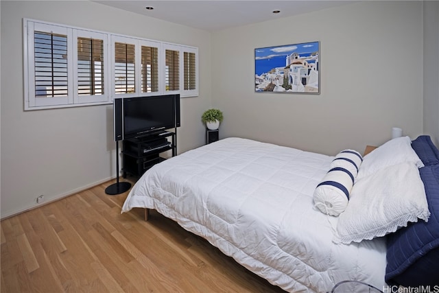 bedroom with hardwood / wood-style flooring