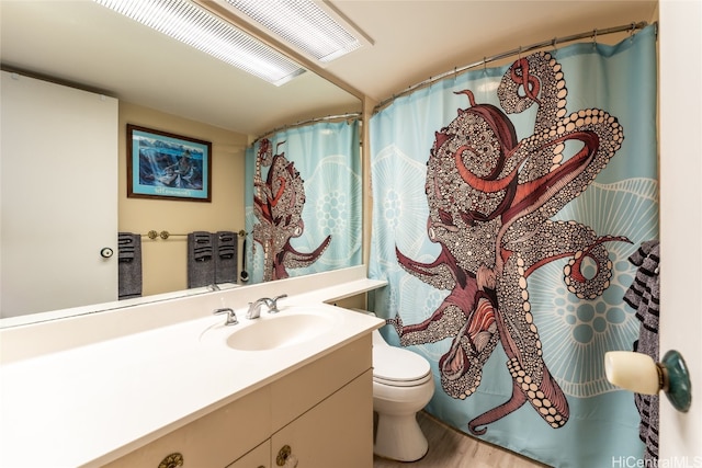 bathroom featuring vanity, hardwood / wood-style flooring, and toilet