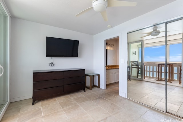 tiled bedroom featuring ceiling fan and ensuite bathroom