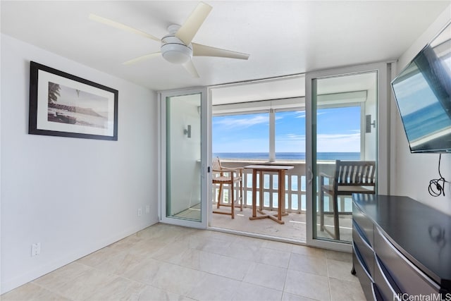 entryway featuring expansive windows, ceiling fan, and light tile patterned floors