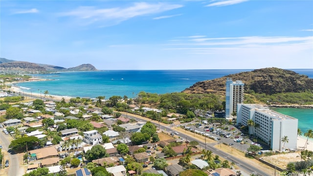 drone / aerial view featuring a water and mountain view