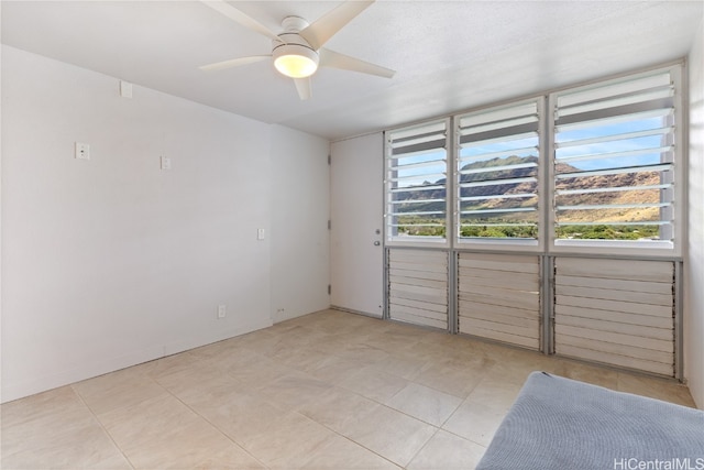 spare room with plenty of natural light and ceiling fan