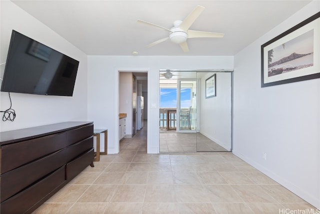 bedroom with white refrigerator, light tile patterned floors, access to exterior, and ceiling fan