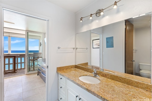 bathroom featuring vanity, tile patterned floors, toilet, and a water view