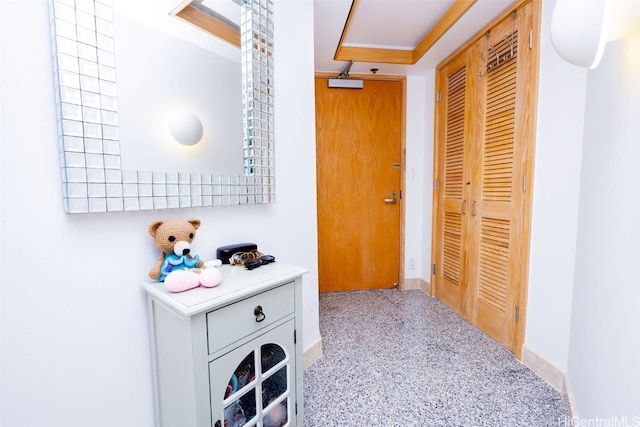 hallway featuring a tray ceiling