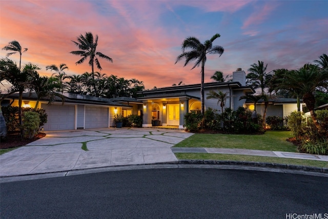 view of front of house with a yard and a garage