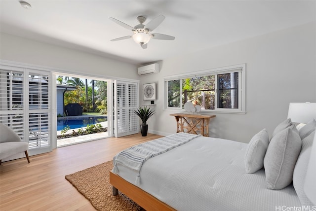 bedroom with light hardwood / wood-style flooring, a wall mounted AC, access to exterior, and ceiling fan