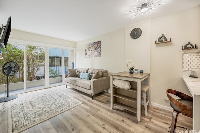 living room featuring light hardwood / wood-style flooring and a chandelier