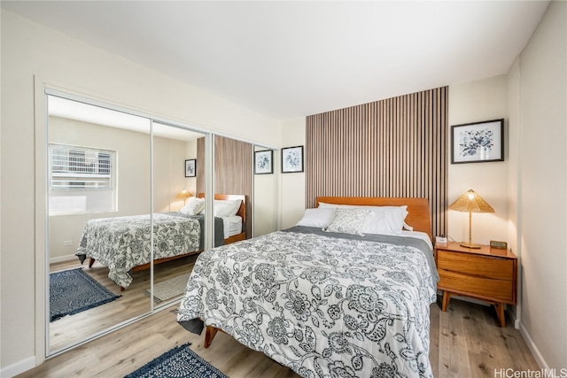 bedroom with a closet and light wood-type flooring