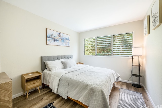 bedroom with hardwood / wood-style floors