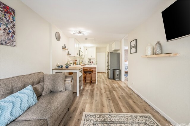 living room featuring light hardwood / wood-style flooring and sink