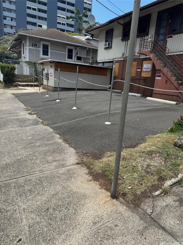 914 Kinau St, Honolulu, HI 96814 - view of car parking featuring cooling unit and stairway