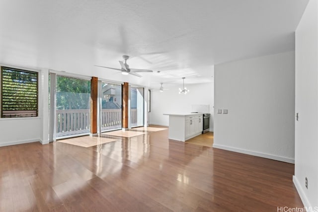 empty room featuring light hardwood / wood-style flooring and ceiling fan with notable chandelier