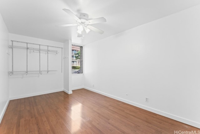 unfurnished bedroom featuring ceiling fan, a closet, and wood-type flooring